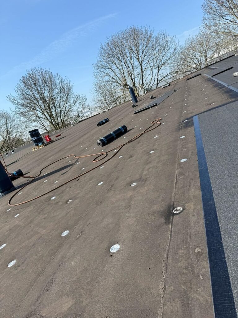 Mechanisch bevestigen van bestaande daklaag op bedrijfspand in Papendrecht